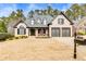 Charming brick home with a well-manicured lawn, black shutters, and a two-car garage at 5810 Ripplestone Nw Ct, Acworth, GA 30101