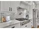 Updated kitchen features stainless steel appliances, white cabinets, subway tile backsplash, and a gas range at 5810 Ripplestone Nw Ct, Acworth, GA 30101