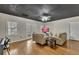 Bright living room featuring hardwood floors, neutral walls, a black ceiling, and modern furniture at 5810 Ripplestone Nw Ct, Acworth, GA 30101