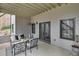 Covered patio with cozy seating, dark-framed doors, and a view of the well-maintained yard at 5810 Ripplestone Nw Ct, Acworth, GA 30101
