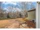 Large backyard with sparse lawn and surrounding trees at 6000 Suttles Sw Dr, Atlanta, GA 30331