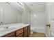 Bathroom with a white countertop, wood vanity, mirror, and tub-shower combo at 6000 Suttles Sw Dr, Atlanta, GA 30331