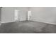 Spacious bedroom with gray carpet, white walls, and doorways to other rooms at 6000 Suttles Sw Dr, Atlanta, GA 30331