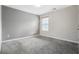 Bedroom featuring plush gray carpet, neutral walls, and natural light from a window at 6000 Suttles Sw Dr, Atlanta, GA 30331