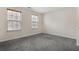 Bedroom with plush gray carpet, neutral paint, and natural light from a window at 6000 Suttles Sw Dr, Atlanta, GA 30331