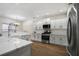 Stylish kitchen features white cabinets, stainless steel appliances, and quartz countertops at 6000 Suttles Sw Dr, Atlanta, GA 30331