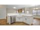 Charming kitchen island with white cabinets, a farmhouse sink, and stainless steel appliances at 6000 Suttles Sw Dr, Atlanta, GA 30331