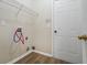 Functional laundry room with hookups, shelving, and a door for privacy at 6000 Suttles Sw Dr, Atlanta, GA 30331