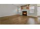 Cozy living room with hardwood floors, a fireplace, and sliding barn door accents at 6000 Suttles Sw Dr, Atlanta, GA 30331
