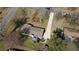 Aerial view of a home with a backyard deck, mature trees, and a long driveway in a quiet neighborhood at 170 Dillard Ne Dr, Kennesaw, GA 30144