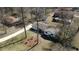 Aerial view of a single-story home with a long driveway and a neighbor's pool in a serene neighborhood at 170 Dillard Ne Dr, Kennesaw, GA 30144