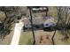 Aerial view of a single-story home with a long driveway flanked by trees and a well-manicured lawn at 170 Dillard Ne Dr, Kennesaw, GA 30144