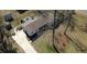 Wide aerial view of the home showing yard, driveway, surrounding landscape, and nearby buildings at 170 Dillard Ne Dr, Kennesaw, GA 30144