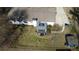 Aerial view of a backyard featuring a covered deck, well-kept lawn, long driveway, and a storage shed at 170 Dillard Ne Dr, Kennesaw, GA 30144