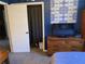 Bedroom with an open closet, a TV on a wooden dresser, and blue accent wall at 170 Dillard Ne Dr, Kennesaw, GA 30144