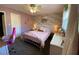 Charming bedroom featuring floral wallpaper, complemented by a whimsical pink chair and white furnishings, creating a cozy space at 170 Dillard Ne Dr, Kennesaw, GA 30144