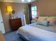 Bedroom featuring a plush bed, vintage dresser, and serene atmosphere at 170 Dillard Ne Dr, Kennesaw, GA 30144