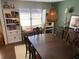 Dining room featuring a large wood table with seating, built-in bookcases, and a decorative light fixture at 170 Dillard Ne Dr, Kennesaw, GA 30144