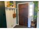 Inviting entryway features a wood door, coat rack with shelf, and charming decorative elements at 170 Dillard Ne Dr, Kennesaw, GA 30144