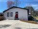 Garage with a red door that adds a pop of color to the exterior at 170 Dillard Ne Dr, Kennesaw, GA 30144