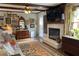 Inviting living room features a fireplace, mounted television, eclectic artwork, and hardwood floors with oriental rug at 170 Dillard Ne Dr, Kennesaw, GA 30144