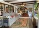 Cozy living room featuring a large sofa, decorative rug, wooden beams, and an eclectic gallery wall at 170 Dillard Ne Dr, Kennesaw, GA 30144