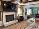 Living room features a brick fireplace, mounted television, and hardwood floors with area rug at 170 Dillard Ne Dr, Kennesaw, GA 30144