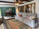 Comfortable living room with a large sectional sofa, decorative rug, and view into the dining area at 170 Dillard Ne Dr, Kennesaw, GA 30144