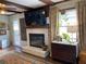 Living room with a brick fireplace, mounted television, and hardwood floors with an oriental area rug at 170 Dillard Ne Dr, Kennesaw, GA 30144