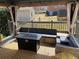 Cozy patio with comfortable wicker furniture, cushions and a fire pit, sheltered by an elegant gazebo structure at 170 Dillard Ne Dr, Kennesaw, GA 30144