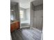 Bathroom boasts vanity sink, corner jacuzzi tub, and shower with gray wood flooring at 2612 Halligan Pointe, Riverdale, GA 30296