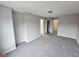 Expansive bedroom showcasing neutral tones, plush carpet, and multiple entryways at 2612 Halligan Pointe, Riverdale, GA 30296