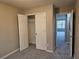 Open closet with wire shelving and neutral carpet, leading to a bright room at 2612 Halligan Pointe, Riverdale, GA 30296