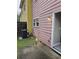 Exterior view of the home's side, with wood siding, a window, and an AC unit at 2612 Halligan Pointe, Riverdale, GA 30296