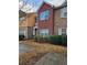 Charming two-story townhome featuring brick and stone facade, complemented by mature landscaping at 2612 Halligan Pointe, Riverdale, GA 30296