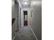 Hallway with carpeting and a view into a bathroom with a wood vanity at 2612 Halligan Pointe, Riverdale, GA 30296