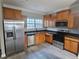 Well-lit kitchen featuring stainless steel appliances and dark countertops and wood cabinets at 2612 Halligan Pointe, Riverdale, GA 30296