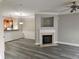Open living room showcasing a fireplace and sleek gray wood floors at 2612 Halligan Pointe, Riverdale, GA 30296