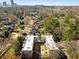 Aerial view showcases the property among mature trees and views of the cityscape at 30 Collier Nw Rd # 6, Atlanta, GA 30309
