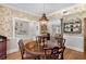 Elegant dining room leading to kitchen boasts a round table and decorative wallpaper at 30 Collier Nw Rd # 6, Atlanta, GA 30309