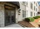 Apartment exterior features double doors, an exterior wall lamp, and manicured landscaping at 30 Collier Nw Rd # 6, Atlanta, GA 30309