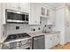 Modern kitchen features stainless steel appliances, granite countertops and white cabinetry at 30 Collier Nw Rd # 6, Atlanta, GA 30309