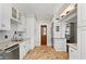 Well-lit kitchen with white cabinets, brick flooring, and a unique wooden door at 30 Collier Nw Rd # 6, Atlanta, GA 30309