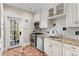 Charming kitchen with white cabinets, granite countertops, and brick flooring, illuminated by natural light at 30 Collier Nw Rd # 6, Atlanta, GA 30309