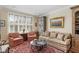 Cozy living room featuring a decorative rug and abundant natural light through plantation-shuttered windows at 30 Collier Nw Rd # 6, Atlanta, GA 30309