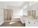 A spacious bathroom features double sinks, a soaking tub, and a separate glass-enclosed shower at 360 Wembley Cir, Atlanta, GA 30328