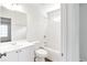 Bright, all-white bathroom with tub/shower combo, modern vanity, and wood-look flooring at 360 Wembley Cir, Atlanta, GA 30328