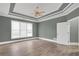 Inviting bedroom features neutral paint, a tray ceiling, and a ceiling fan at 360 Wembley Cir, Atlanta, GA 30328