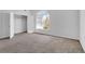 A bright bedroom with a large arched window and walk-in closet provides lots of natural light at 360 Wembley Cir, Atlanta, GA 30328