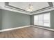 Cozy bedroom features neutral paint, white trim, and a tray ceiling with a ceiling fan at 360 Wembley Cir, Atlanta, GA 30328